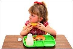 unhappy girl with school lunch tray