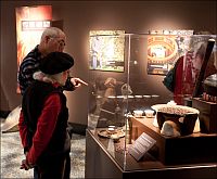 visitors pointing at history of coffee display