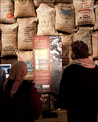 visitors looking at shade-grown coffee display