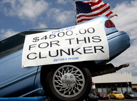 A vehicle sits in a dumpster on display in front of Bill Wink Chevrolet dealership to attract customers in for the Cash For Clunkers program in Dearborn, Michigan August 6, 2009. (Rebecca Cook / Reuters)