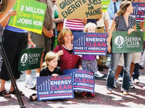 activists with clean-energy signs