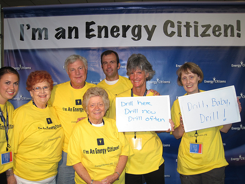 Women in front of Energy Citizen banner.