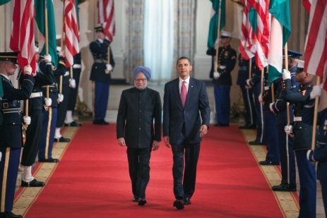 President Barack Obama and Prime Minister Singh of India walk along the Cross Hall of the White House towards the East Room for the arrival ceremony.