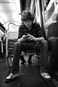 guy texting on subway