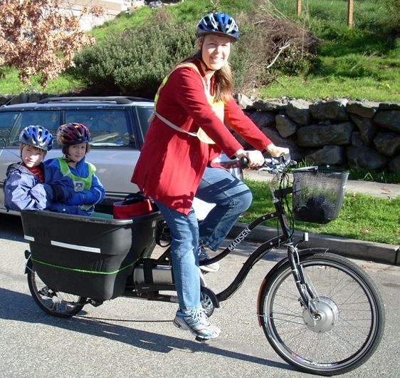 Lady on electric bike with children. 