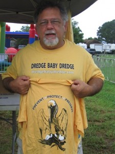 Man holding "Dredge Baby Dredge" shirt.
