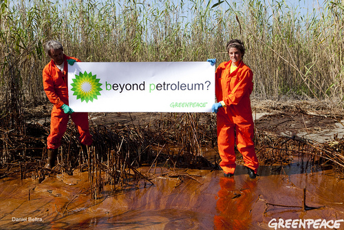activists with BP sign in sludge