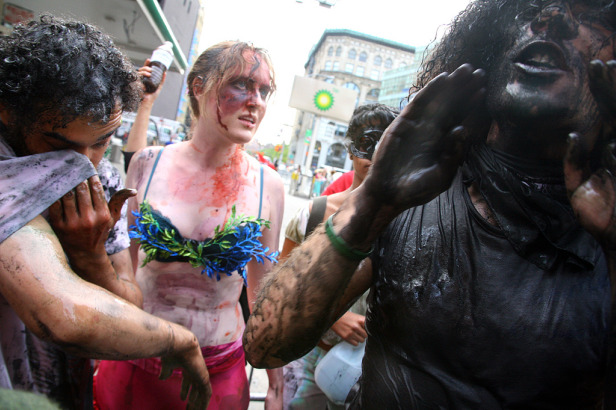 Protesters covered in oil.