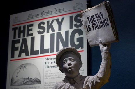 boy holding "sky is falling" sign