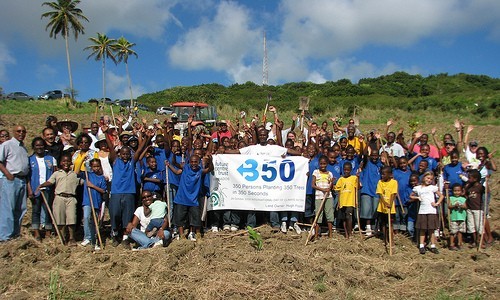 People holding a 350 sign.