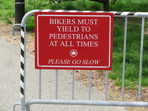 Bikers must yield to pedestrians sign