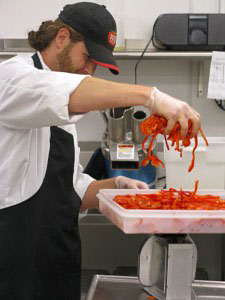 Worker weighing peppers