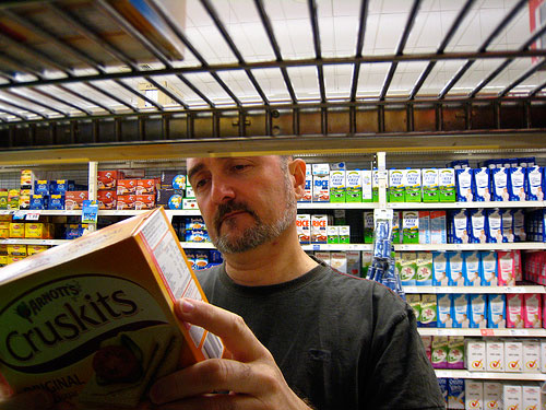 Man reading grocery label