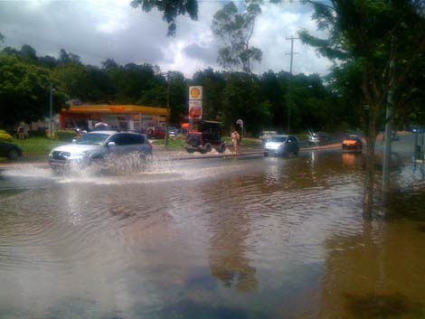 Cars drive through floodwaters in Brisbane