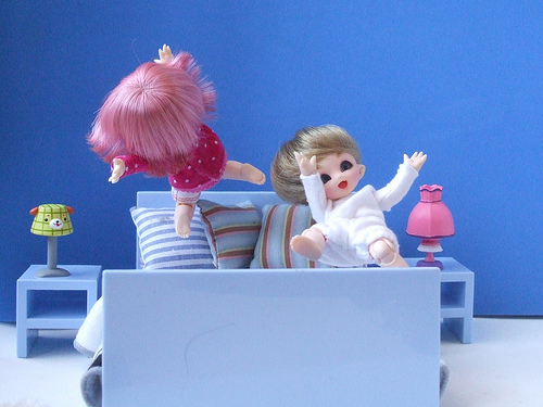 Dolls jumping on bed