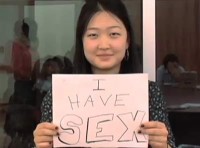 young woman holding "i have sex" sign