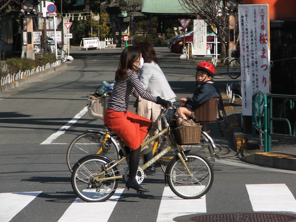 Woman on bike in Tokyo.