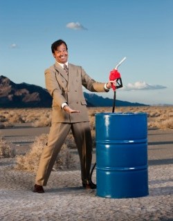 smiling man with oil barrel