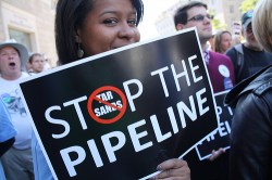 Protestor with "Stop the Pipeline" sign
