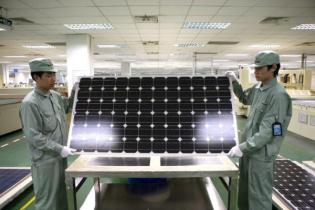 Chinese workers with a solar panel