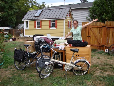 Lina Menard with her possessions, sitting outside a tiny home she lived in for 10 months. 