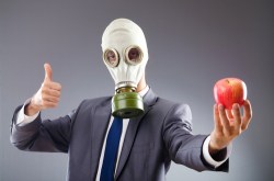 man with gas mask and apple