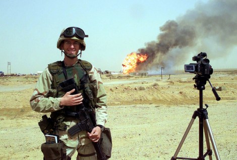 An American soldier stands near a 2006 oil field fire near Kirkuk