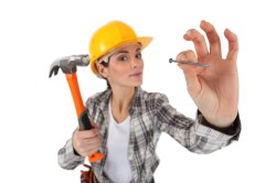 woman with hammer and nail
