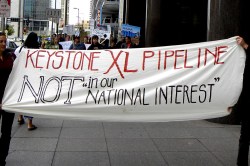 protest banner: "Keystone XL pipeline not in our national interest"