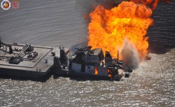 This photo, taken Wednesday, shows how close the barge is to the burning tug and pipeline. Inside the barge and not visible from the outside is 2,200 barrels of crude oil, according to the Coast Guard.