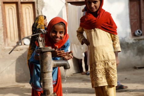 Children in Sindh, Pakistan, play at a water pump in a village near Dadu, in Sindh, Pakistan.