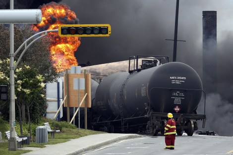 A firefighter walks past a burning train wagon at Lac Megantic, Quebec, July 6, 2013.