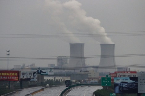Power plant stacks tower over a town in China's coal country.