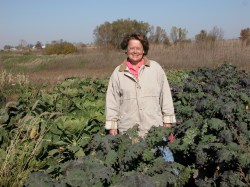 Laura Krause in a field of kale