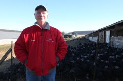 Mr. Koch stands proudly before his flock of turkeys.