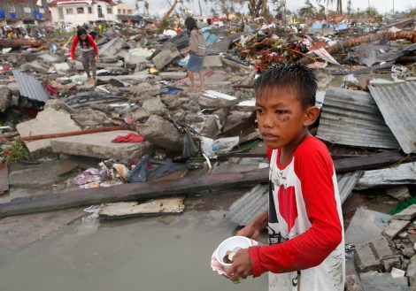 boy at scene of devastation caused by Typhoon Haiyan