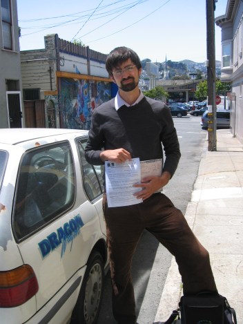 I posed for a picture with the title and final failed smog check before giving up the Dragon Wagon