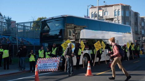 A Google bus surrounded by protestors.