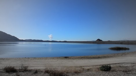 Water pours silently and invisibly into the Lake Perris reservoir. 