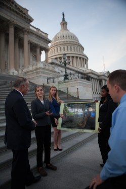 Project Localize students Ania Chamberlin, Cassie Kramer and Tessa Musa, with their teacher Mike Todd, share with Iowa Rep. Steve King (left) the story of a veteran, Jeff Hafner, who transformed his family's CAFO farm into a sustainable aquaponics farm in Iowa.