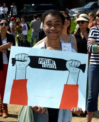 girl with "pipeline fighter" sign