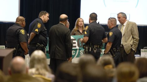Police arrest Alexis Baden-Mayer of the Organic Consumers Association.