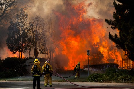 Firefighters battle the so-called Poinsettia Fire in Carlsbad, California May 14, 2014.