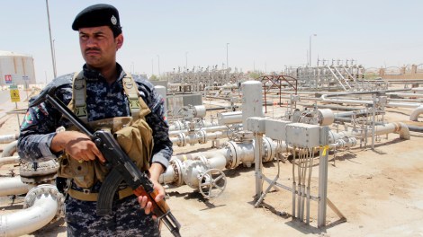 A member from the oil police force stands guard at Zubair oilfield in Basra, southeast of Baghdad June 18, 2014.