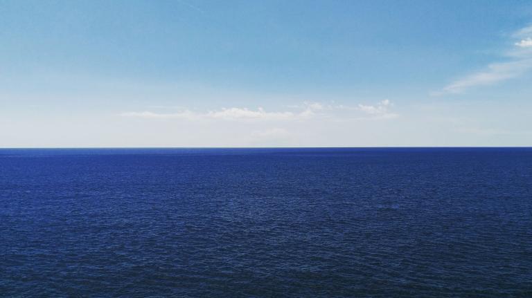 Calm ocean against sky