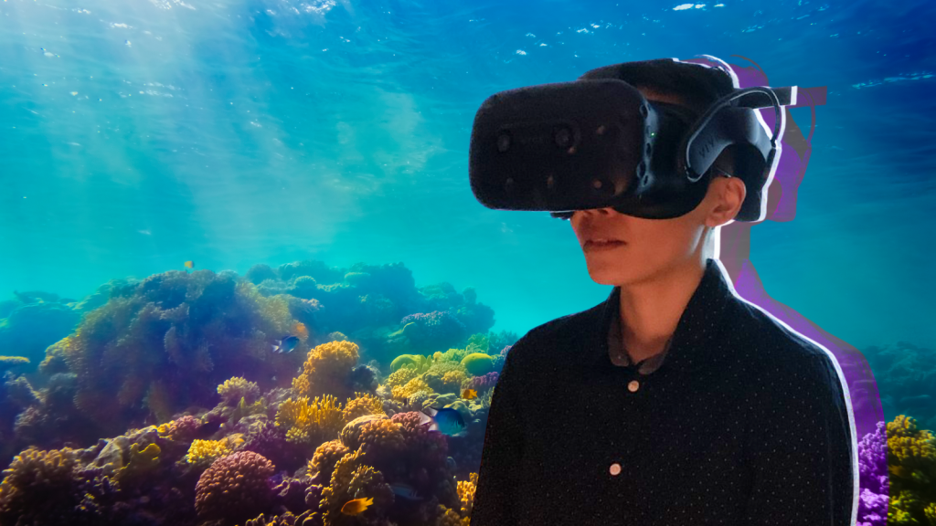 A young student wearing VR goggles, overtop of a coral reef background