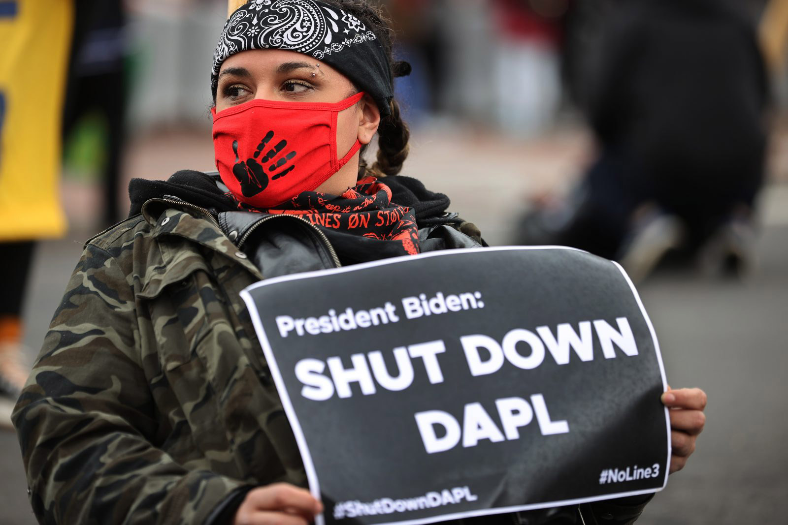 Woman holding a sign protesting the Dakota Access Pipeline