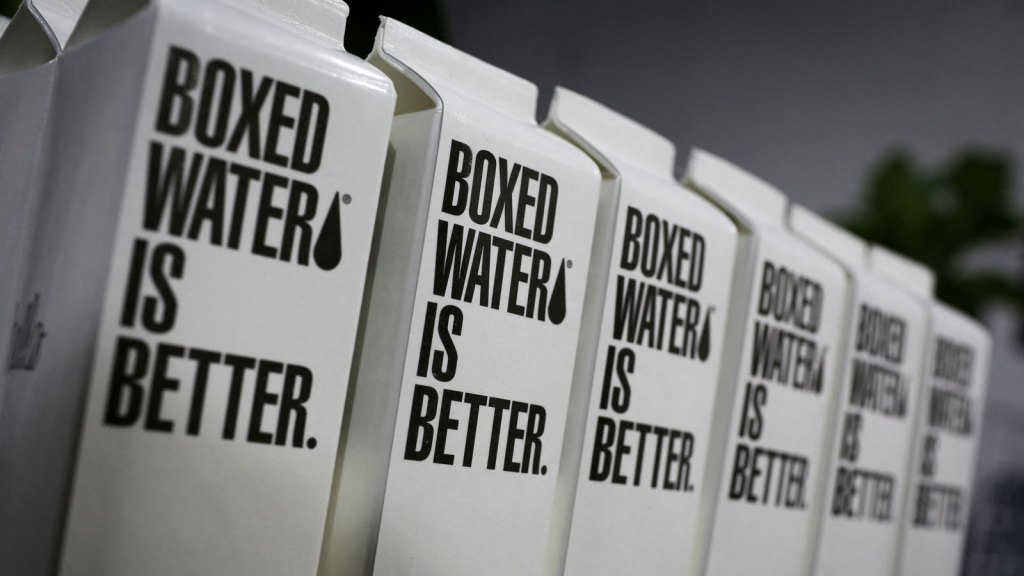 Cartons of Boxed Water Is Better lined up on a shelf