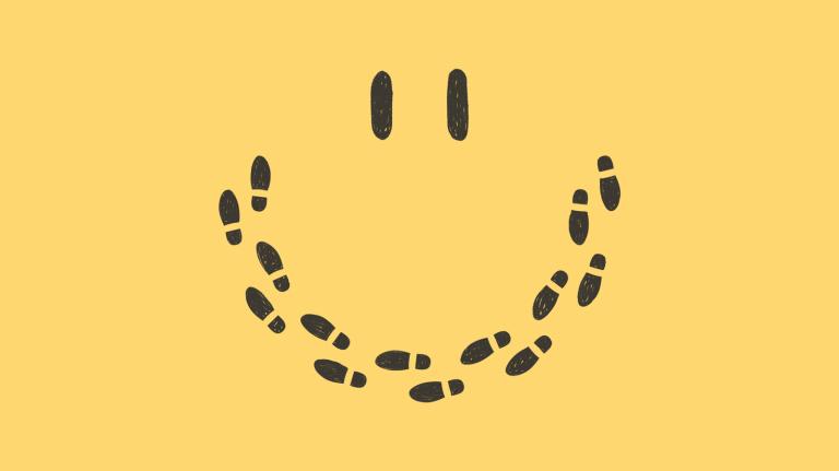 Conceptual illustration of smiley face made up of footprints on yellow background