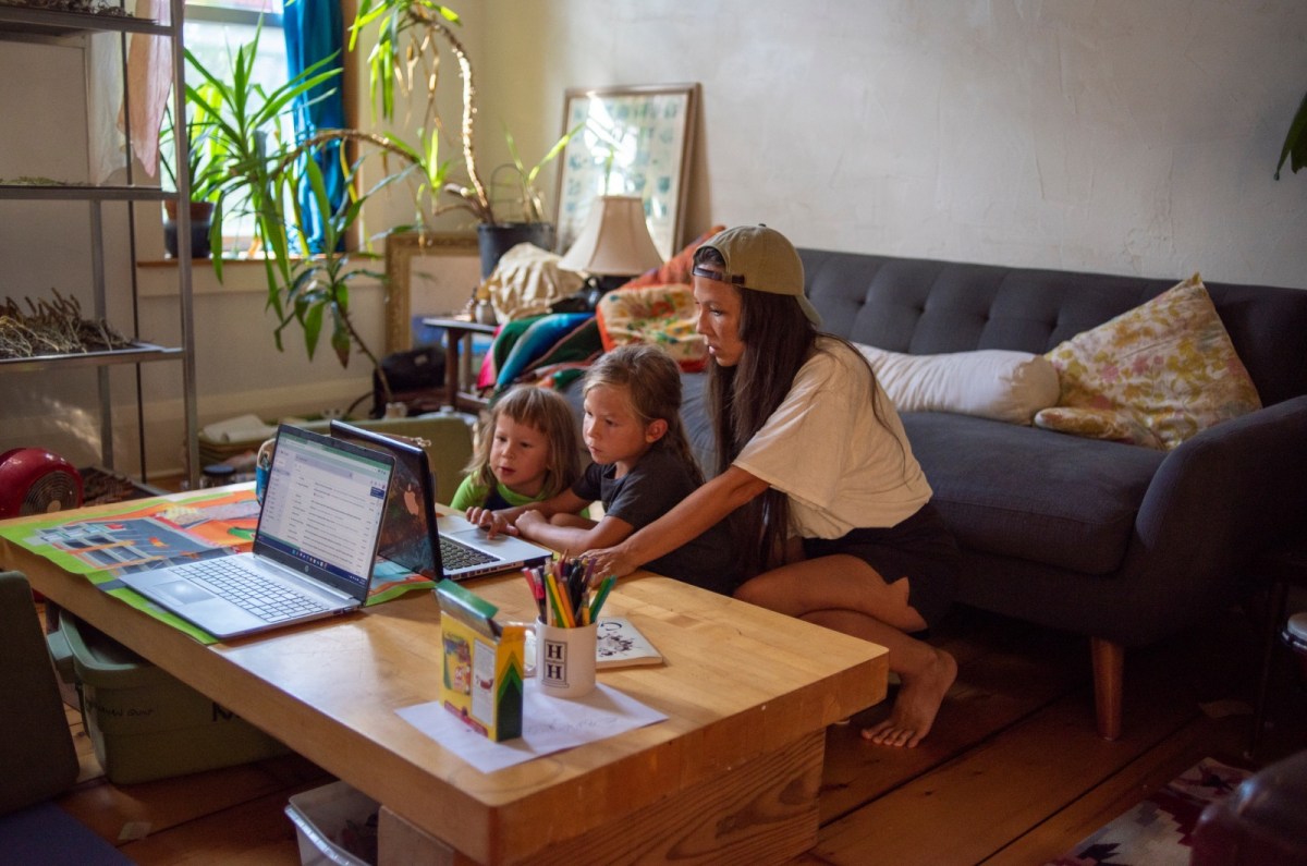 Azuré Keahi, accountant for Soul Fire Farm, working alongside her children at home.